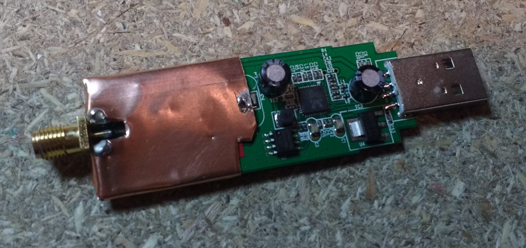 Shielding applied to the RF section of the RTL-SDR.com dongle with the intention of reducing spurii from the onboard USB and DC-DC converter.